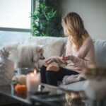 Pet-friendly Plants - woman sitting on sofa while holding food for dog