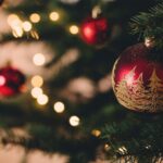 Holiday Decorations - shallow focus photography of red bauble on christmas tree