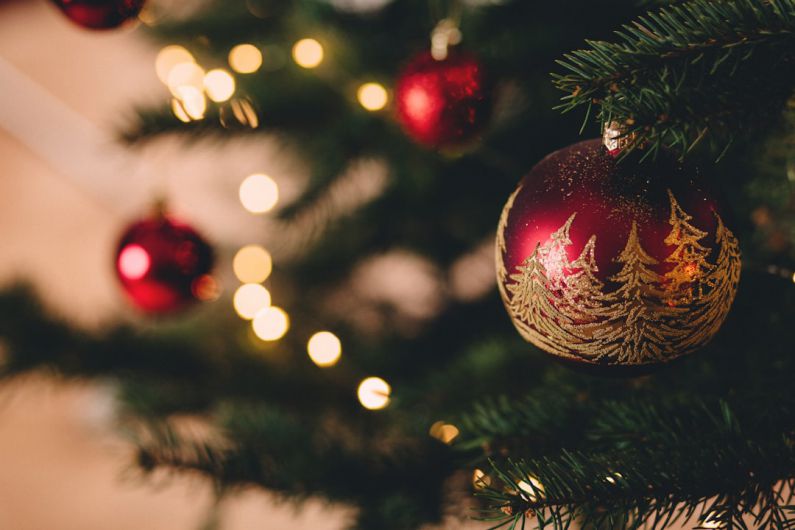 Holiday Decorations - shallow focus photography of red bauble on christmas tree