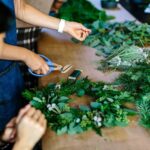 Wreaths - person holding scissors and leaf wreath