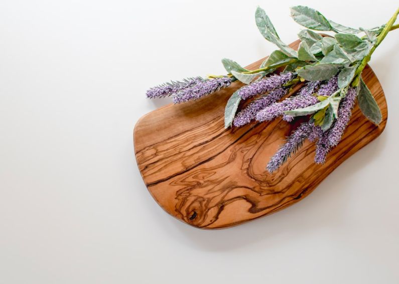 Aromatherapy Decor - green and purple leaves on brown wooden chopping board