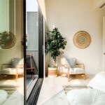 Natural Light - white and brown wooden armchair beside white and brown round wall mirror