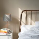 Restful Bedroom - table lamp on white wooden nightstand beside bed