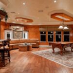 Home Gym Flooring - billiard table in center of brown painted room