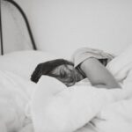 Under-bed Storage - grayscale photo of sleeping woman lying on bed