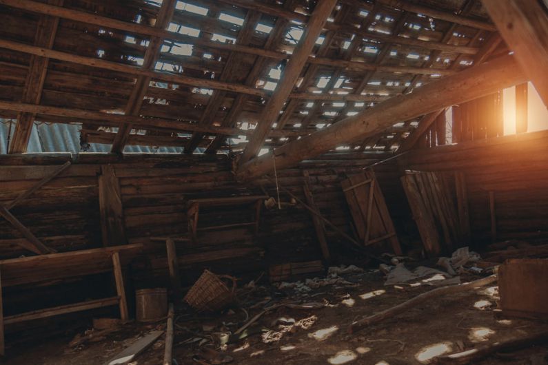 Attic Storage - a room with wood beams and wood floors