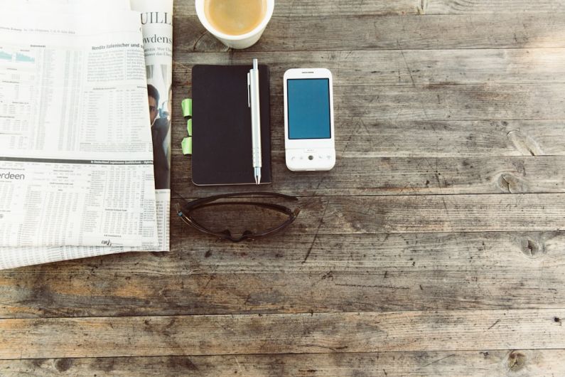 Shoe Storage - pen beside mobile phone on wooden surface